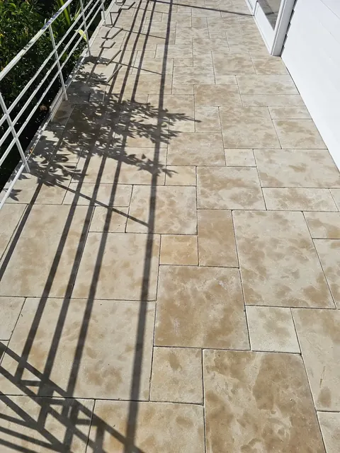 Travertine-look tiled balcony walkway
