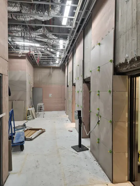 Lift lobby corridor with large-format wall tiles in progress