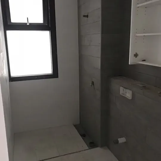 Grey bathroom during tiling