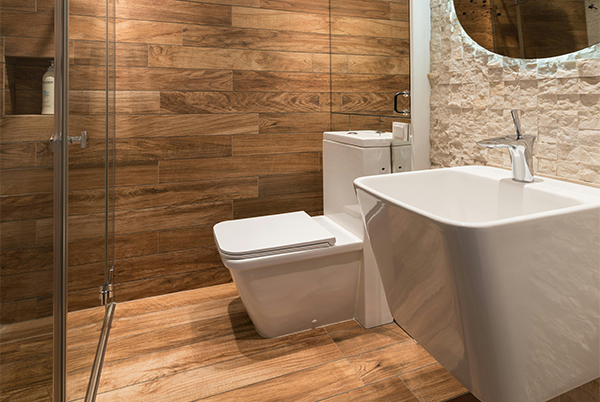 Timber-look tiled bathroom with stone feature wall