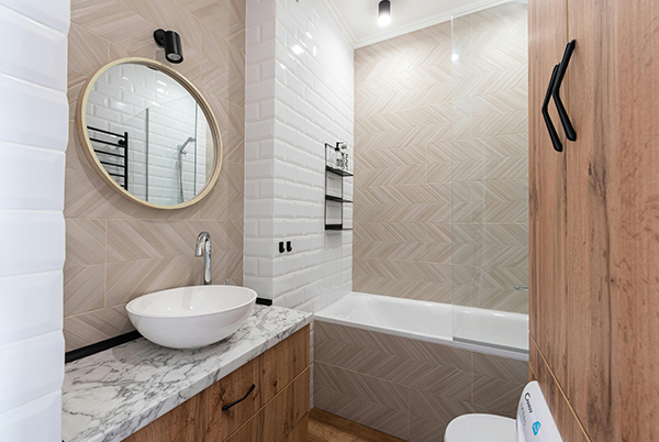 Completed bathroom renovation with herringbone wall tile